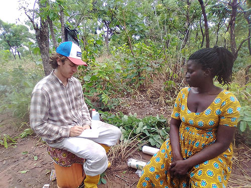 Colin interviewing a farmer after a day of work.