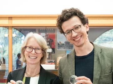 Stephanie Newell and Egor Lazarev pose with their awards