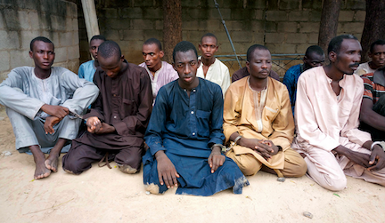 A group of men that Nigerian police identified as Boko Haram extremist fighters. A new study suggests messages from trusted religious leaders can persuade people to welcome former members of the terrorist group back into their communities. (Photo AP/Jossy Ola)